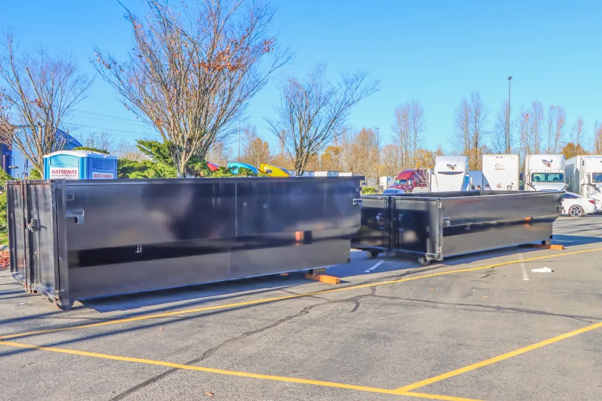 Professional dumpster rental service with roll-off container on residential driveway in Edwards